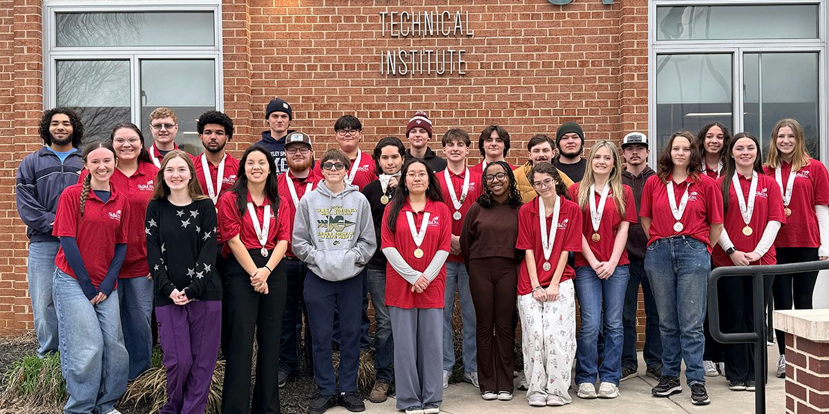 SkillsUSA competitors posing in front of the school.