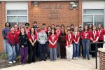 SkillsUSA competitors posing in front of the school.